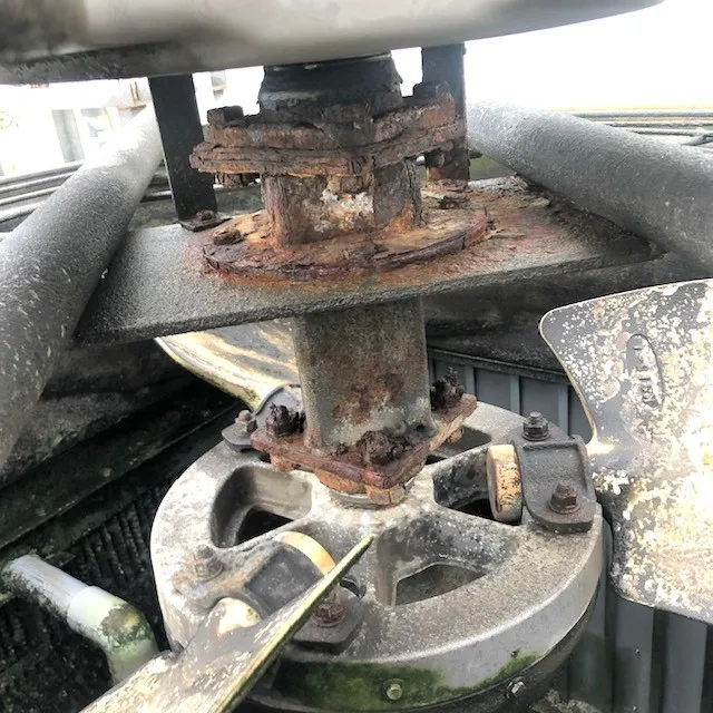 Cooling tower bearing unit before maintenance — worn from extended operation