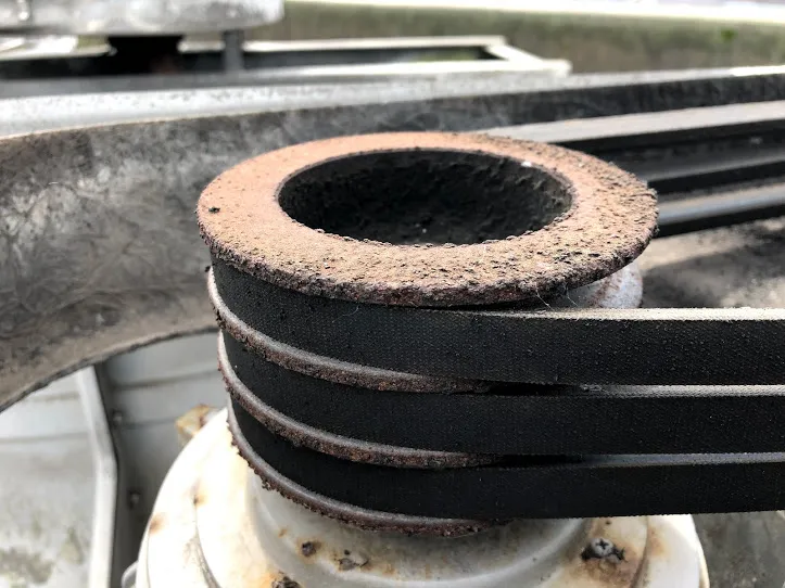 Drive belt pulley before maintenance — worn and degraded