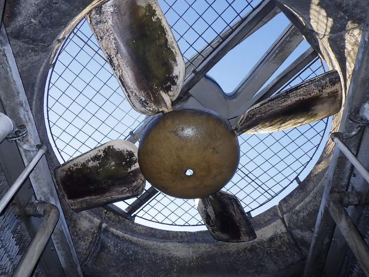 Cooling tower fan blade before maintenance — cracked and weathered