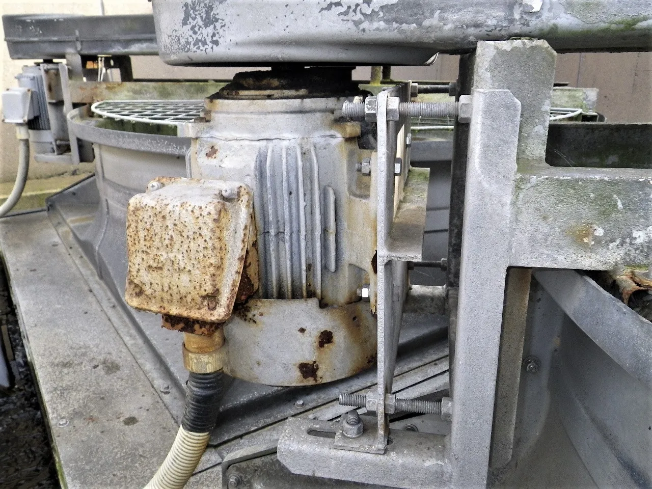 Cooling tower motor before maintenance — heavily corroded and worn